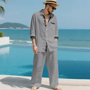 A full-length view of a men's grey linen casual two-piece set in a resort poolside setting.