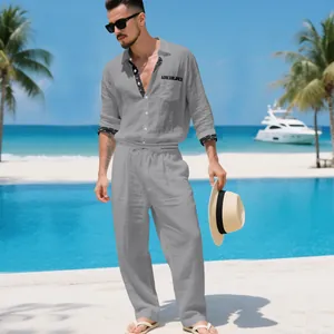 Casual grey men's linen shirt and pants two-piece set in a tropical resort setting.