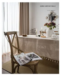 European minimalist linen cotton tablecloth with tassel trim in a cozy dining setting
