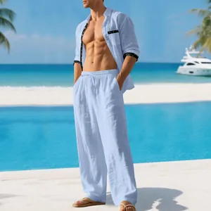 Men's light blue linen shirt and trousers set displayed by model on sunny beach