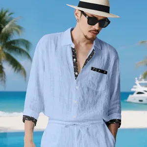 Close-up of men's casual light blue linen shirt and trousers set with patterned trim