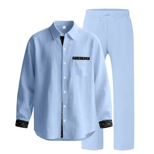 Detail view of light blue men's linen two-piece set with patterned black trim accents