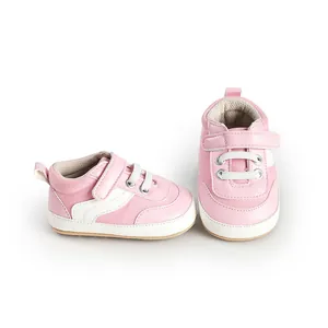 Close-up of pink and white baby canvas walking shoes with convenient velcro straps