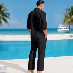 Detailed back view of men's black leisure linen two-piece set at a tropical beach resort