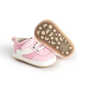 Detail showing pink baby canvas pre-walker sneakers with anti-slip rubber soles