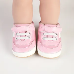 Close-up of pink baby canvas walking shoes with soft soles and velcro straps
