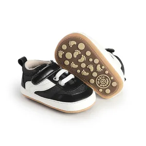 Detail showing texture and anti-slip soles of black and white baby canvas prewalker shoes