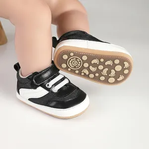 Detailed view of black and white baby prewalker shoes with anti-slip footprint sole