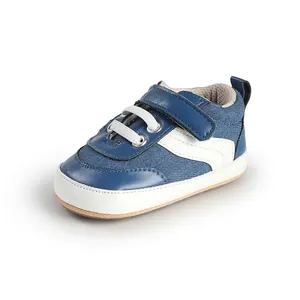 Detail of blue and white baby walking shoe with secure velcro strap and soft sole