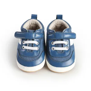 Top-down view of blue and white baby canvas sneakers with hook-and-loop strap