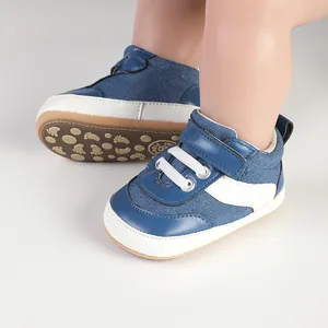 Detail showing the blue canvas baby walking shoes with anti-slip footprint soles.