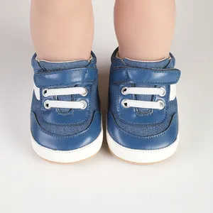 Close-up of blue baby canvas toddler shoes with hook-and-loop strap on doll feet