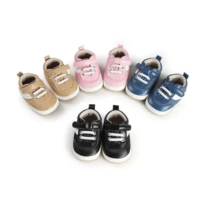 Detailed view of colorful infant baby pre-walker shoes in pink, blue, black, and tan.