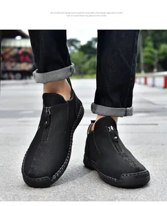 Close-up of black leather casual shoes with front zipper and hand-stitched detail