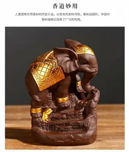 Detailed view of a purple clay elephant backflow incense burner with ornate gold accents.