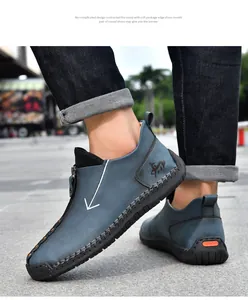 Close-up of men's blue-grey casual leather shoes with side zipper and hand-stitched details