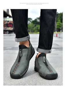 Detailed view of men's grey casual leather shoes with zipper and manual stitching