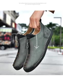 Close-up of men's casual leather boots featuring front zipper and hand-stitched detailing