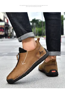 Detail of men's tan leather casual shoes with hand-stitched seams and zipper