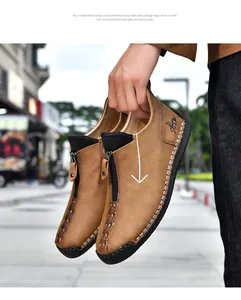 Close-up of men's brown leather casual boots featuring zipper and hand-stitched detail