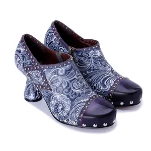 Detail of genuine leather printed high heels with rivet studs and hand-rubbed toe cap