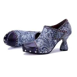 Detailed view of women's leather paisley print high heels with silver rivet accents