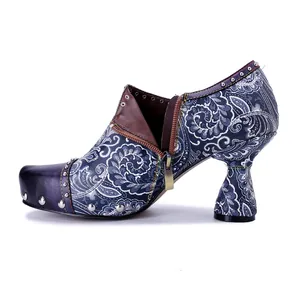 Detailed side view of bohemian floral leather high heels with unique heel and rivets