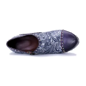 Top view of floral print leather high heels with rivet details and colorful stitching