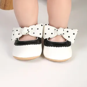 Close-up of baby girl princess pre-walker shoes with white and black polka-dot bows