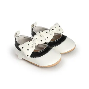 Detail view of stylish baby girl princess shoes with polka dot bows for first walkers
