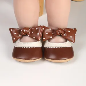 Infant girl brown Mary Jane princess shoes featuring a polka dot bow and lace trim