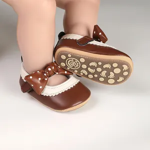 Macro view of brown baby girl princess shoes with bow detail and anti-slip sole