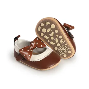 Detailed view of brown baby pre-walker shoes with polka dot bow and anti-slip sole