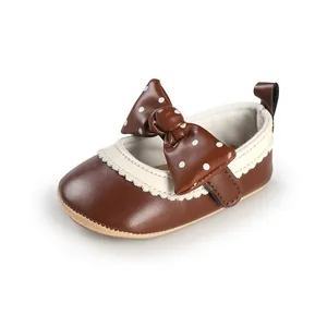 Close-up of brown baby princess walking shoe featuring a cute polka dot bow detail