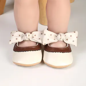 Adorable cream baby girl princess shoes with large polka-dot bow for infant walking