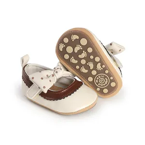 Detailed view of baby girl princess pre-walker shoes with bow and non-slip sole.