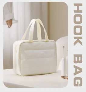 Large capacity white quilted travel toiletry bag with sturdy handheld handles and hook
