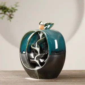 Elegant apple-shaped ceramic backflow incense burner with teal and black glaze finish