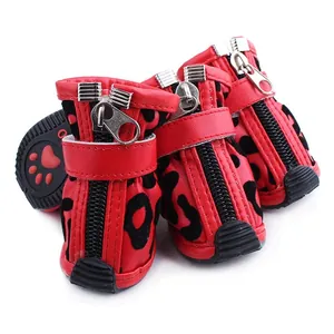 Close-up of red dog shoes with leopard print, zipper and velcro strap