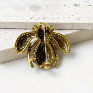 Detailed back view of vintage gold-tone bee brooch with secure pin clasp mechanism