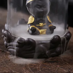 Atmospheric Sun Wukong backflow incense burner with glass windproof cover and lotus base.