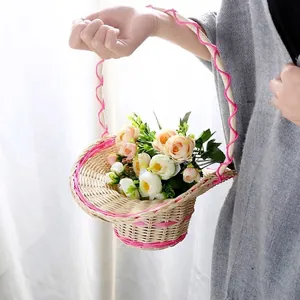 Handmade woven rattan flower basket with pink decorative handle for home decor