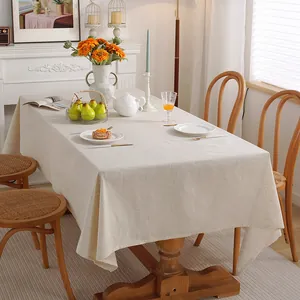 Solid color cotton linen rectangular tablecloth in a warm dining room setting