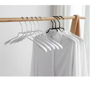 Close-up view of minimalist non-marking anti-slip clothes hangers on a wooden rack