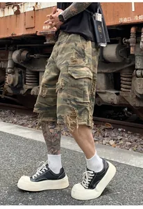 Close-up detail of vintage distressed camouflage cargo shorts for men in a relaxed fit.