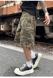 Side detail of vintage camouflage cargo shorts with heavy ripped elements and stonewashed finish