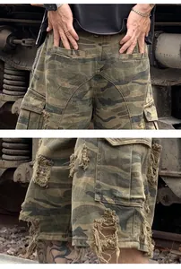 Detail view of distressed camo cargo shorts featuring heavy ripped and stone-washed textures.