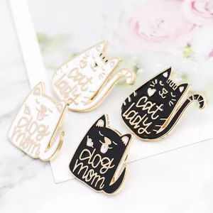 Close-up detail of cartoon cat and dog enamel pins with Cat Lady and Dog Mom text