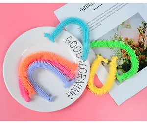 Detailed close-up of colorful stretchy alpaca-shaped sensory fidget toys on a plate