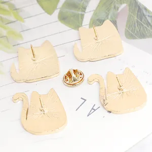 Detailed view of the gold-plated metal backs and clutch for cat-shaped pins